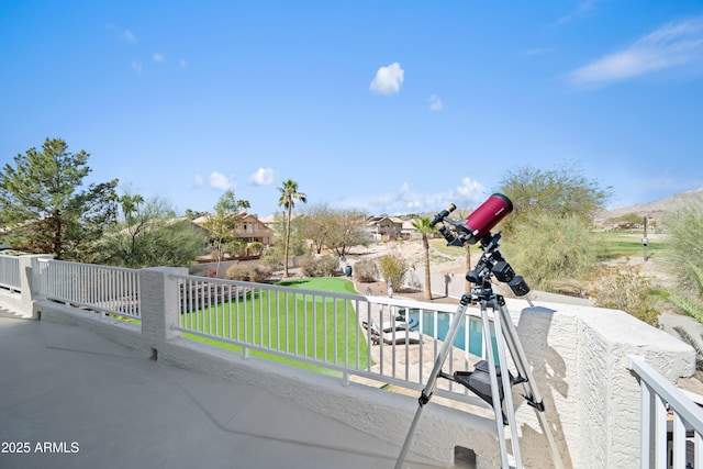 view of patio / terrace with a fenced in pool and a balcony