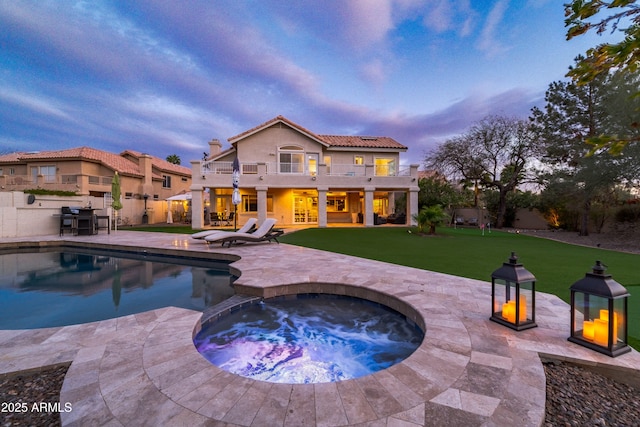 view of pool featuring grilling area, a fenced in pool, a yard, a patio area, and an in ground hot tub