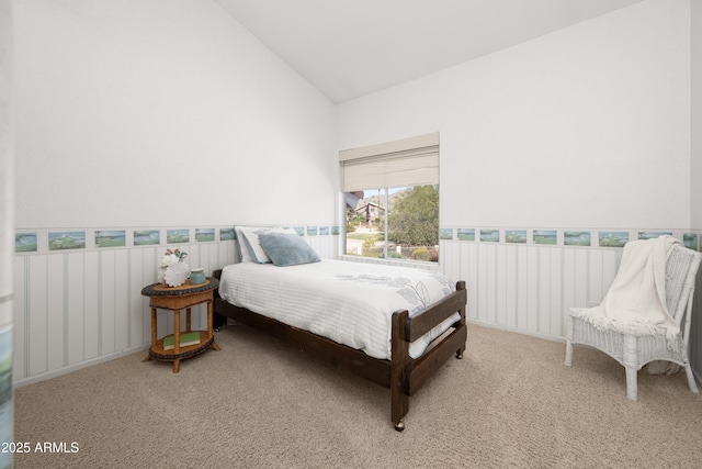 bedroom with carpet flooring and high vaulted ceiling