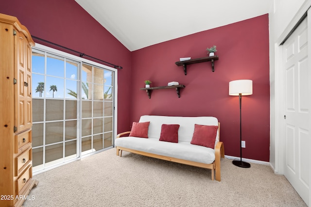 living area with lofted ceiling, carpet flooring, and baseboards