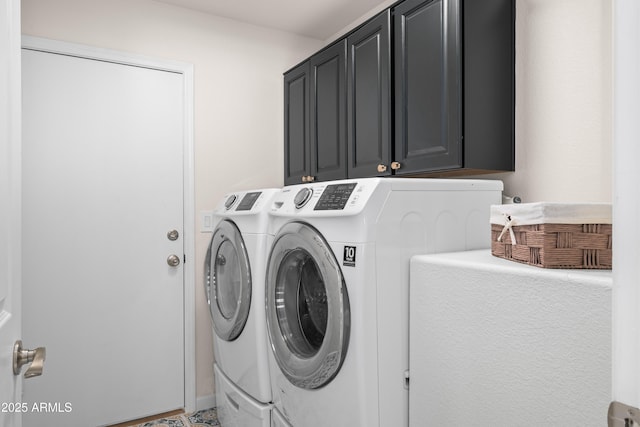 washroom with cabinet space and separate washer and dryer