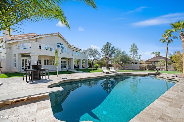 view of pool featuring fence, a fenced in pool, french doors, a patio area, and a lawn