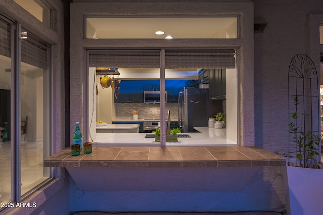 entrance to property with stucco siding