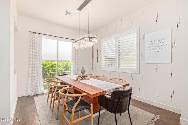 dining room featuring dark hardwood / wood-style flooring and a notable chandelier