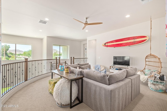 carpeted living room featuring ceiling fan