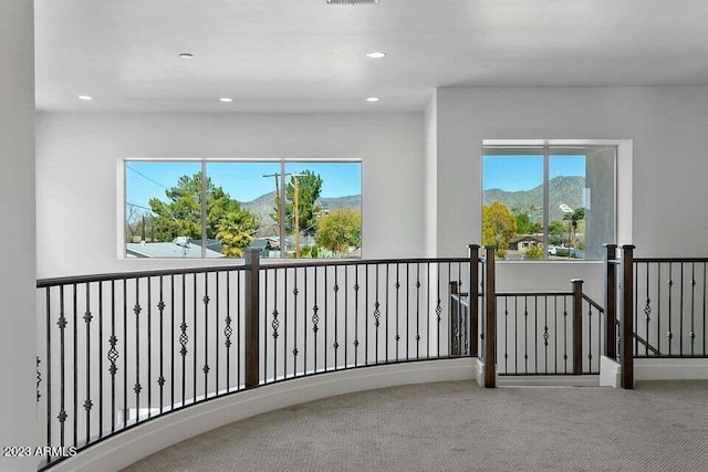 corridor with a mountain view and carpet