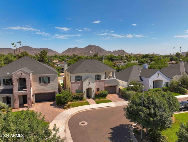 view of front of home with a garage and a mountain view