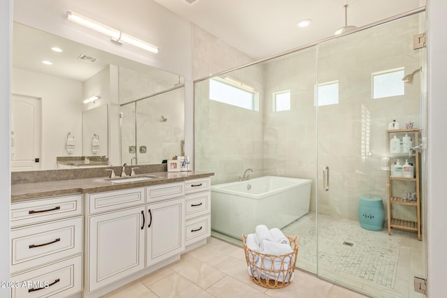 bathroom with vanity, tile patterned flooring, shower with separate bathtub, and tile walls