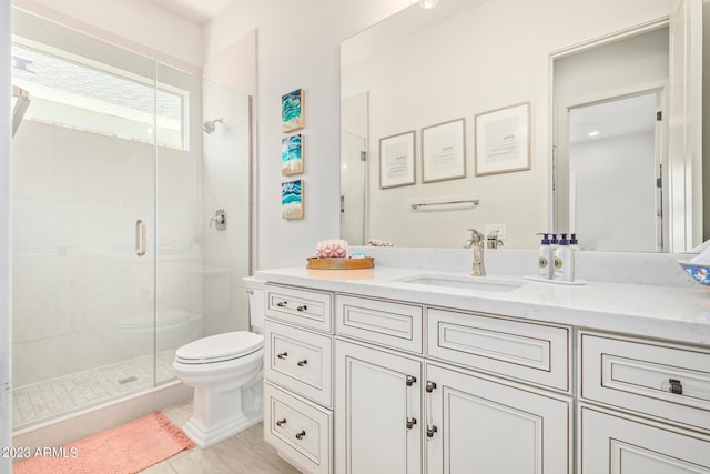 bathroom featuring an enclosed shower, vanity, tile patterned flooring, and toilet