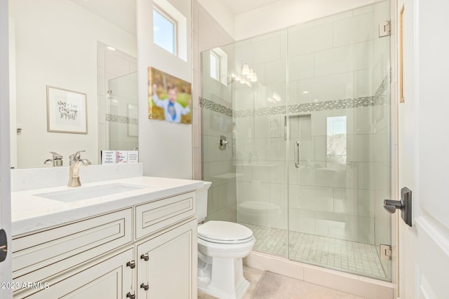 bathroom with toilet, an enclosed shower, and vanity