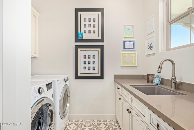 laundry room featuring cabinets, sink, light tile patterned flooring, and washing machine and clothes dryer