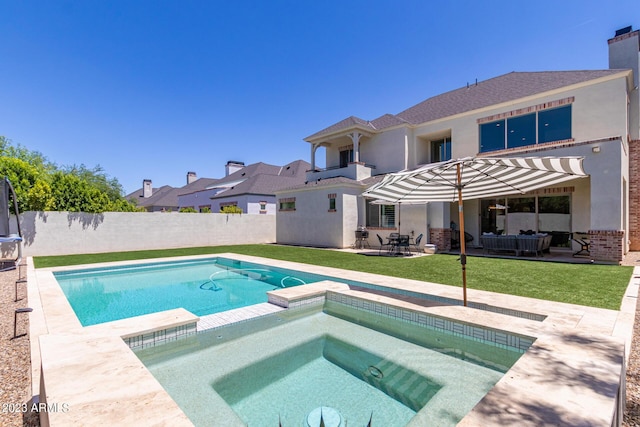 view of pool featuring a patio area, an in ground hot tub, and a lawn