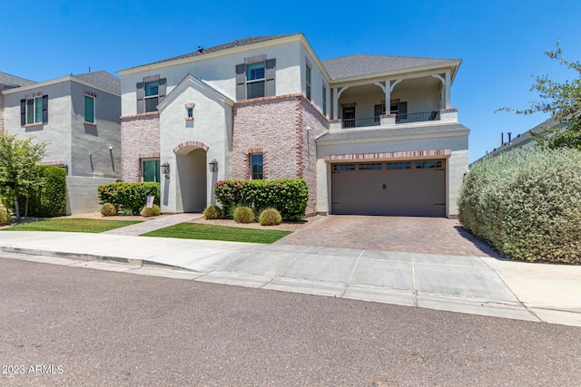 view of front of home featuring a balcony and a garage