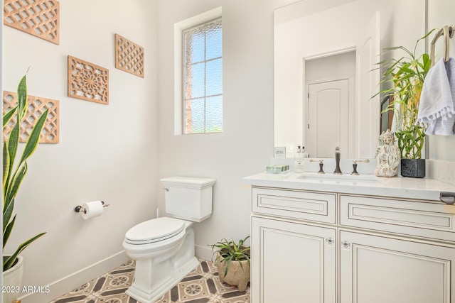 bathroom featuring toilet, tile patterned flooring, and vanity