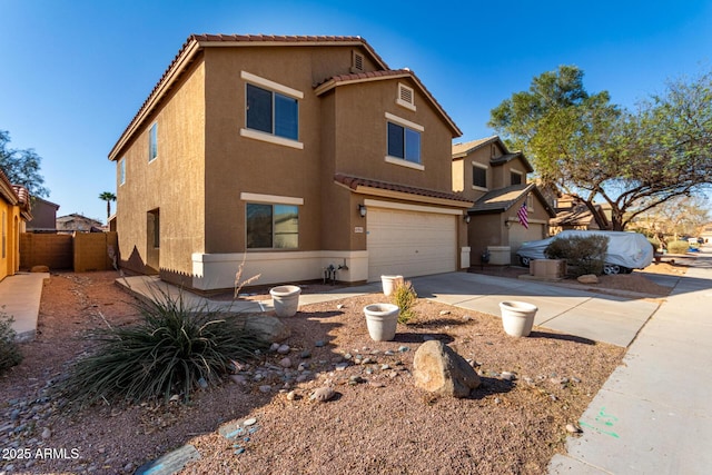 view of front of house featuring stucco siding, concrete driveway, fence, a garage, and a tiled roof