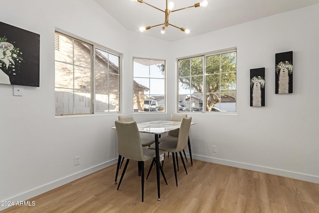 dining space featuring light hardwood / wood-style flooring and a chandelier