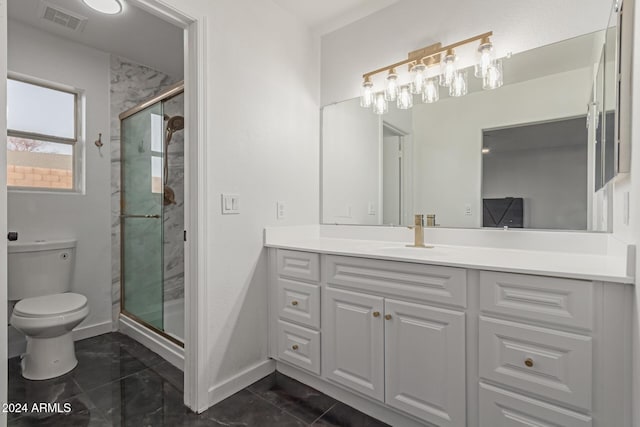 bathroom with vanity, toilet, and a shower with door