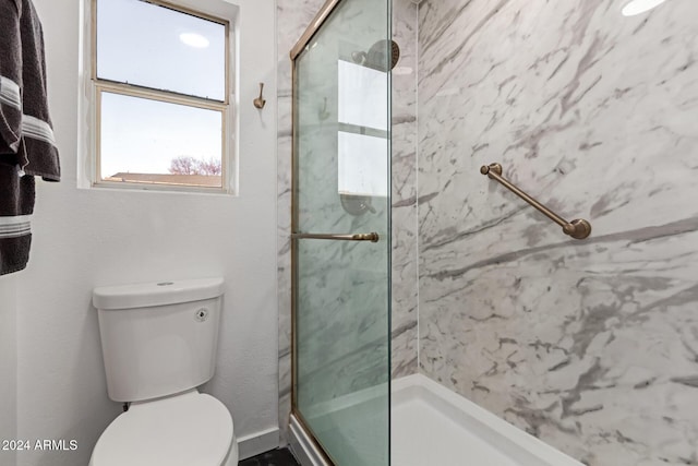 bathroom featuring an enclosed shower and toilet