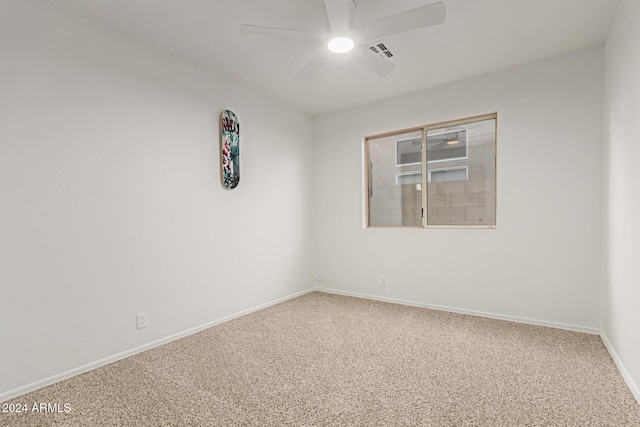 spare room featuring ceiling fan and carpet