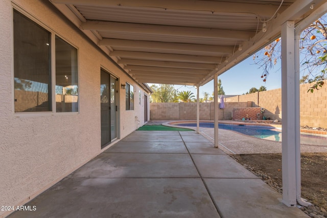 view of patio with a fenced in pool