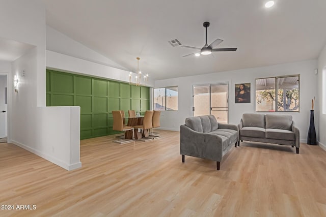 living room featuring lofted ceiling, a wealth of natural light, and light hardwood / wood-style floors