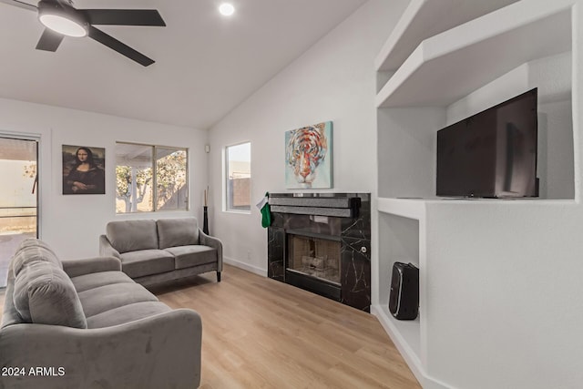 living room with lofted ceiling, light wood-type flooring, and ceiling fan