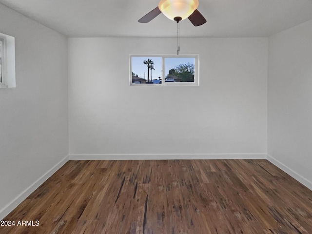 unfurnished room with ceiling fan and dark hardwood / wood-style floors