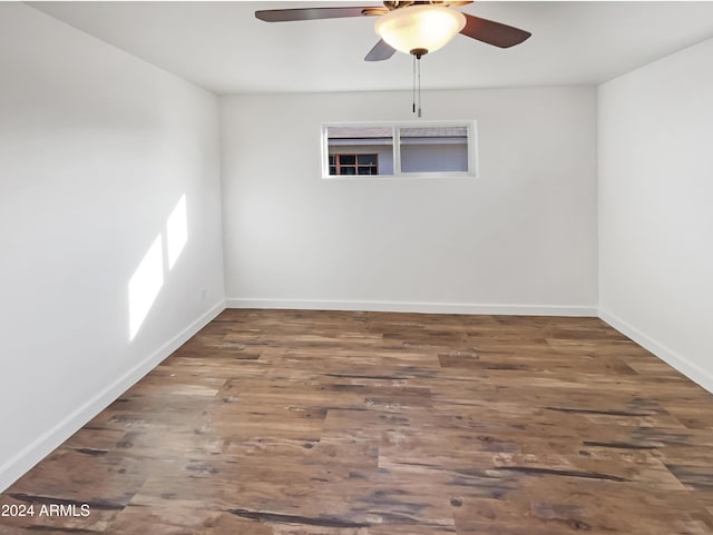 unfurnished room featuring dark hardwood / wood-style floors and ceiling fan