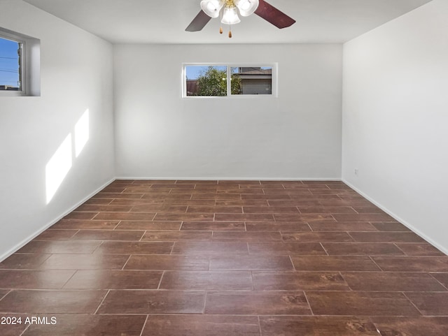 empty room with dark hardwood / wood-style flooring and ceiling fan