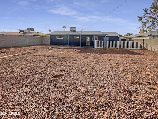 rear view of house featuring cooling unit