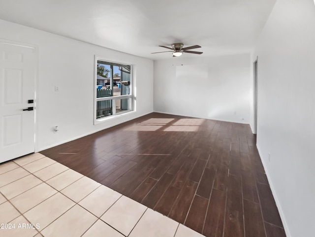 empty room with hardwood / wood-style floors and ceiling fan