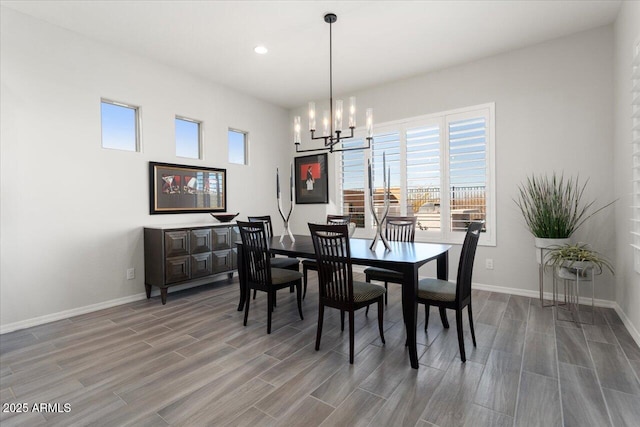 dining area with a notable chandelier and hardwood / wood-style flooring