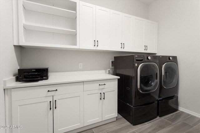 laundry room featuring cabinets and washer and dryer