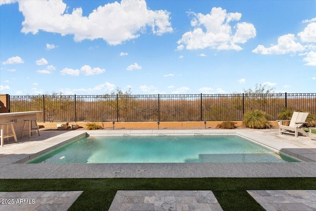 view of pool with a patio area and a bar