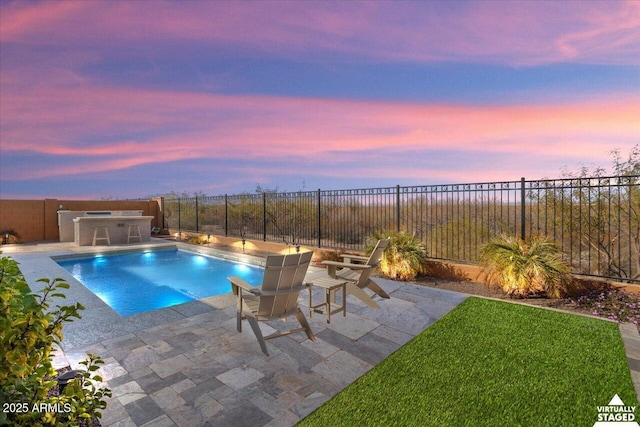 pool at dusk featuring a patio area