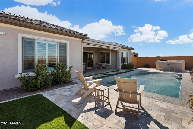 view of swimming pool with a patio area and exterior bar