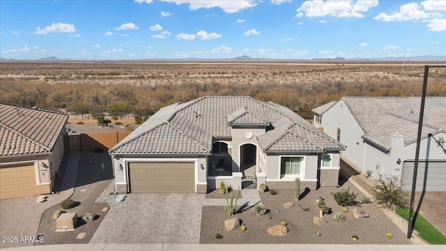 view of front of property with a garage and a mountain view