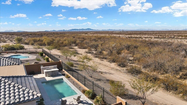 birds eye view of property with a mountain view