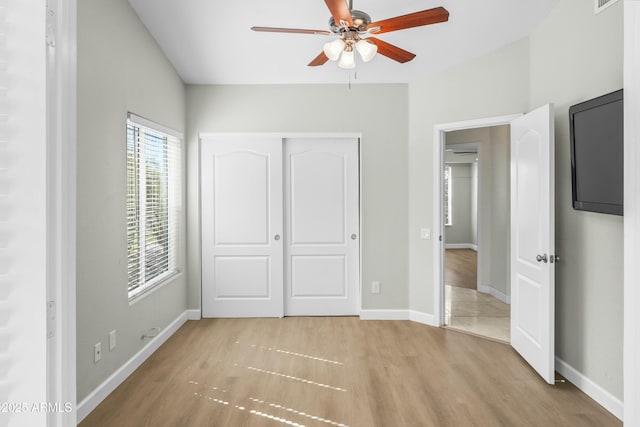 6920 W Via Montoya Dr, Glendale, AZ 85310 - unfurnished bedroom featuring a closet, baseboards, a ceiling fan, light wood-style floors, and visible vents