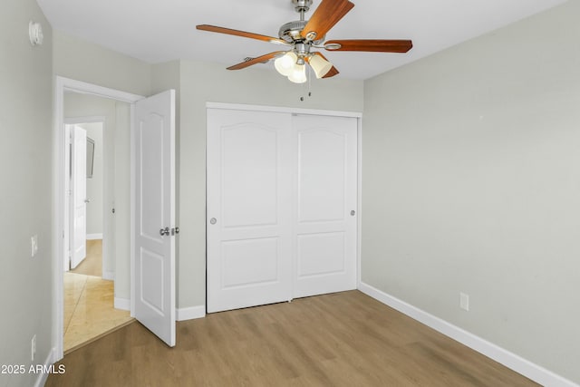 6920 W Via Montoya Dr, Glendale, AZ 85310 - unfurnished bedroom featuring a closet, light wood-style flooring, a ceiling fan, and baseboards