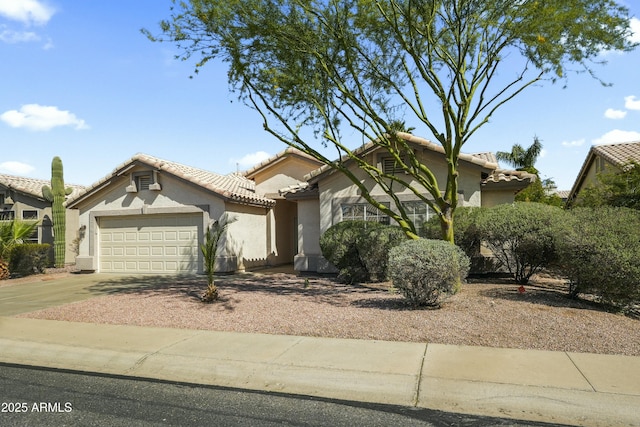 6920 W Via Montoya Dr, Glendale, AZ 85310 - view of front of home with driveway, a tile roof, a garage, and stucco siding