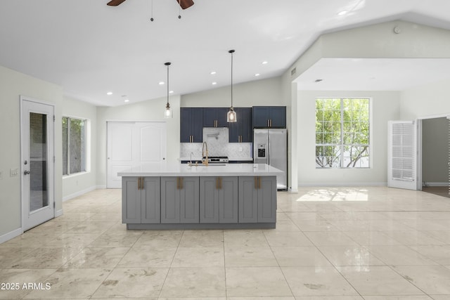 6920 W Via Montoya Dr, Glendale, AZ 85310 - kitchen with stainless steel fridge with ice dispenser, tasteful backsplash, light countertops, ceiling fan, and vaulted ceiling
