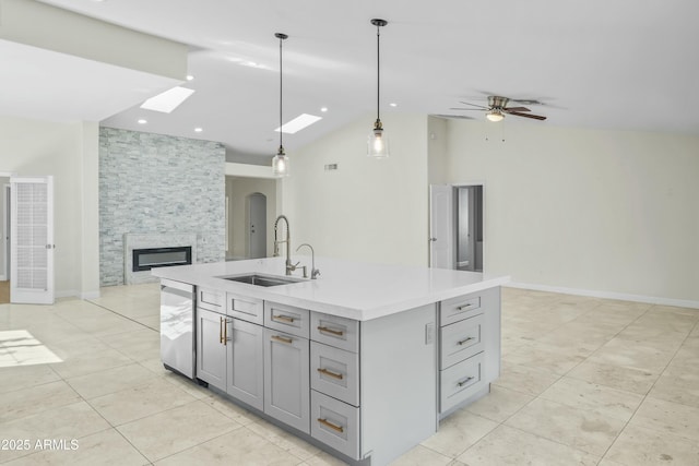 6920 W Via Montoya Dr, Glendale, AZ 85310 - kitchen featuring gray cabinets, a skylight, a sink, light countertops, and open floor plan