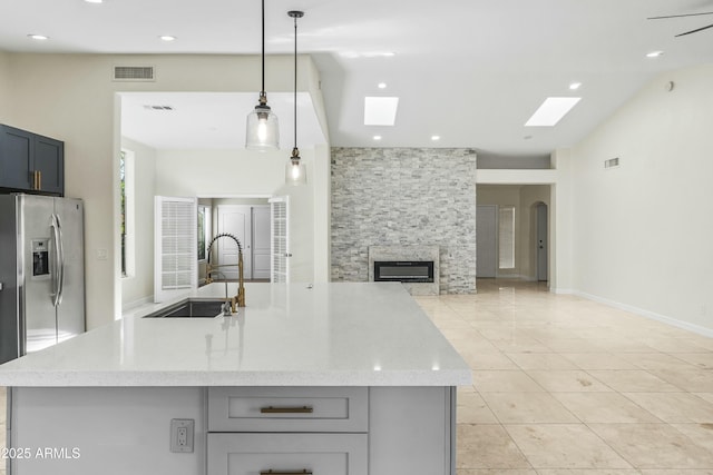 6920 W Via Montoya Dr, Glendale, AZ 85310 - kitchen featuring open floor plan, visible vents, a sink, and a skylight