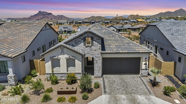 5724 E Scarlet St, Mesa, AZ 85215 - french country inspired facade featuring stucco siding, an attached garage, a residential view, decorative driveway, and a mountain view