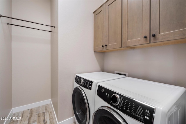 5724 E Scarlet St, Mesa, AZ 85215 - laundry room with cabinet space, washing machine and clothes dryer, and light wood-type flooring