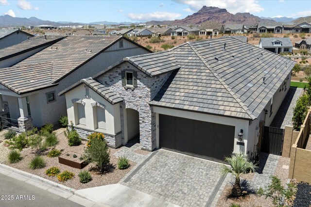 5724 E Scarlet St, Mesa, AZ 85215 - french country style house featuring stucco siding, stone siding, and a mountain view
