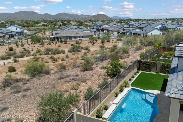 5724 E Scarlet St, Mesa, AZ 85215 - view of swimming pool with a residential view, a mountain view, and a fenced backyard