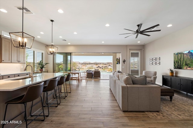 5724 E Scarlet St, Mesa, AZ 85215 - living area with wood finished floors, recessed lighting, ceiling fan, and a chandelier