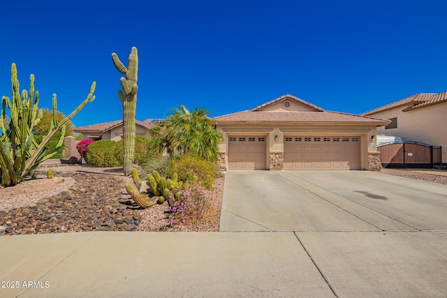 view of front of property featuring an attached garage, stone siding, concrete driveway, a gate, and stucco siding